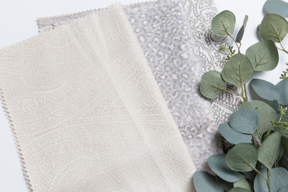 Neutral fabric swatches arranged for a custom Christmas pajama material review