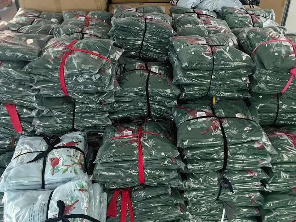 Bundles of polybagged printed pajama sets tied and stacked for shipment