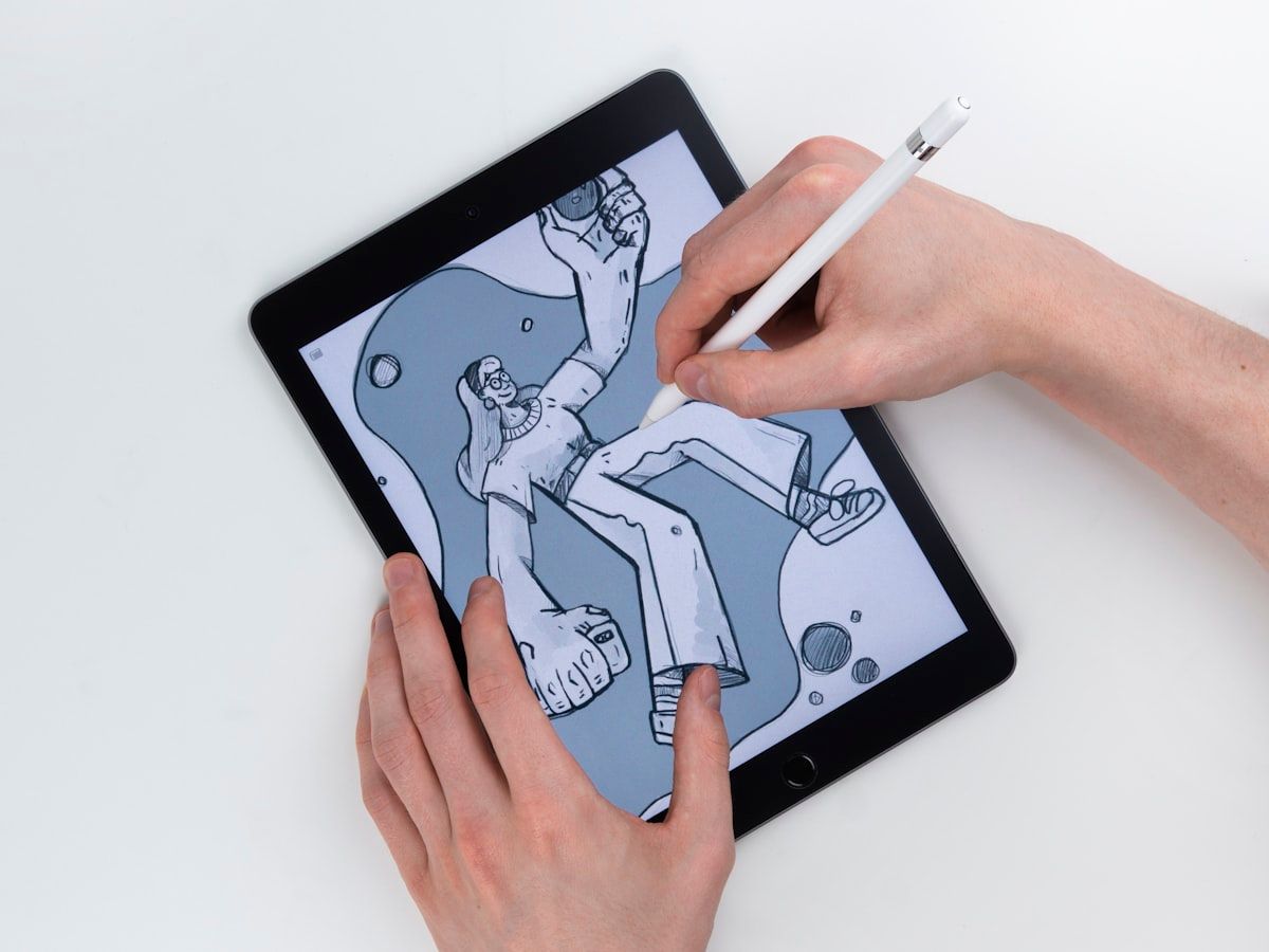 Illustrator drawing an original character on a graphics tablet with a stylus