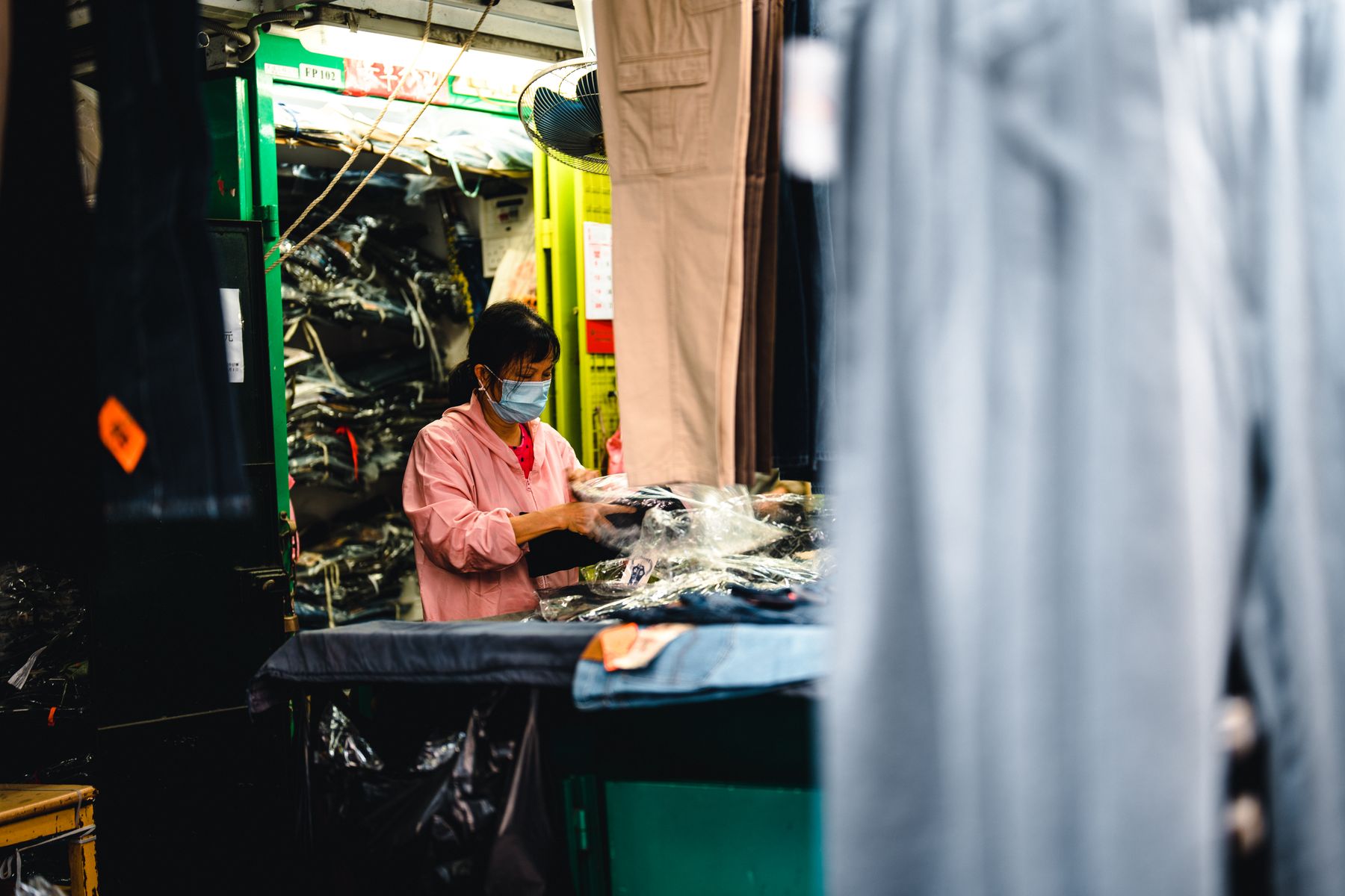 Worker packing garments in a production area