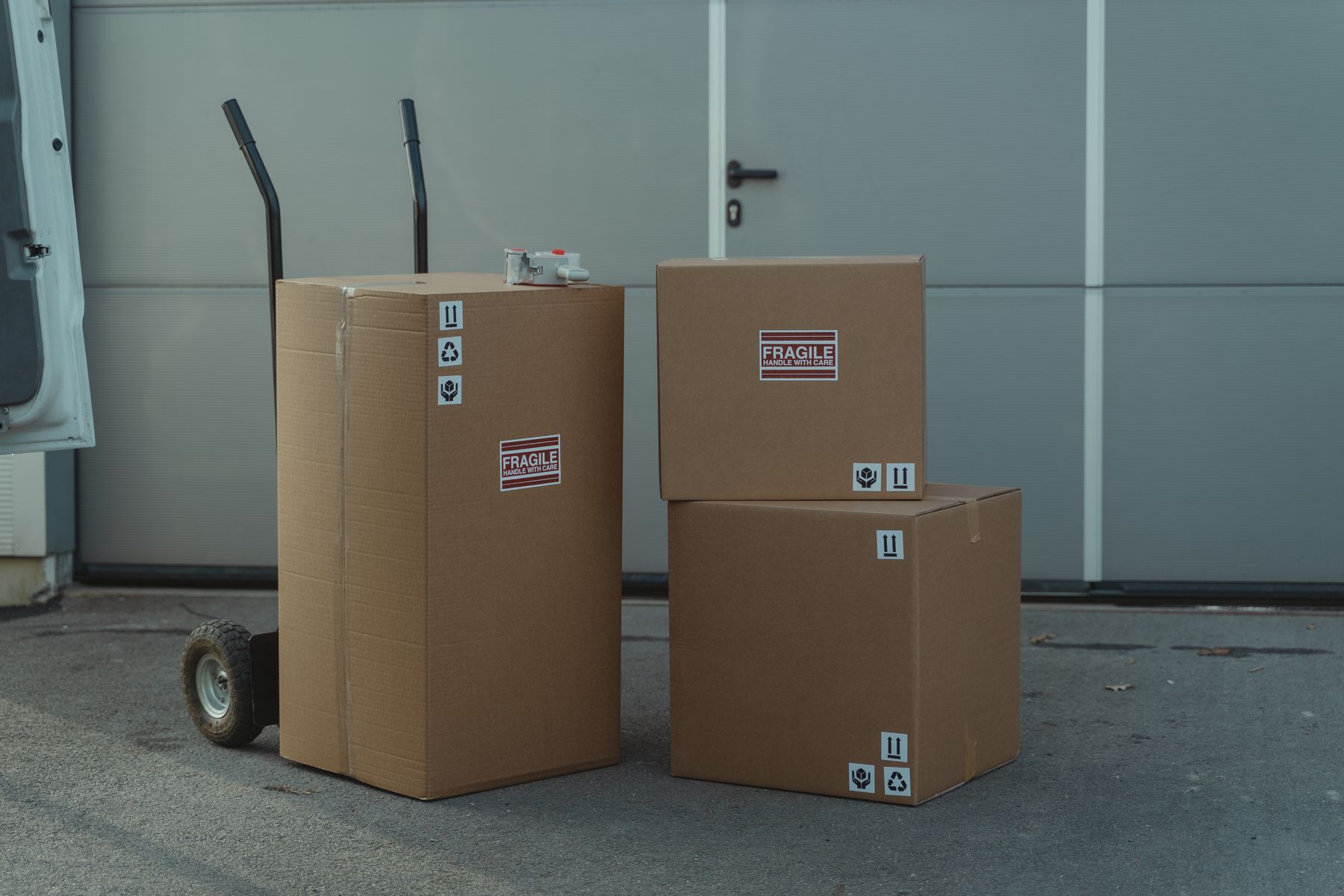 Cardboard shipping cartons stacked on a warehouse trolley