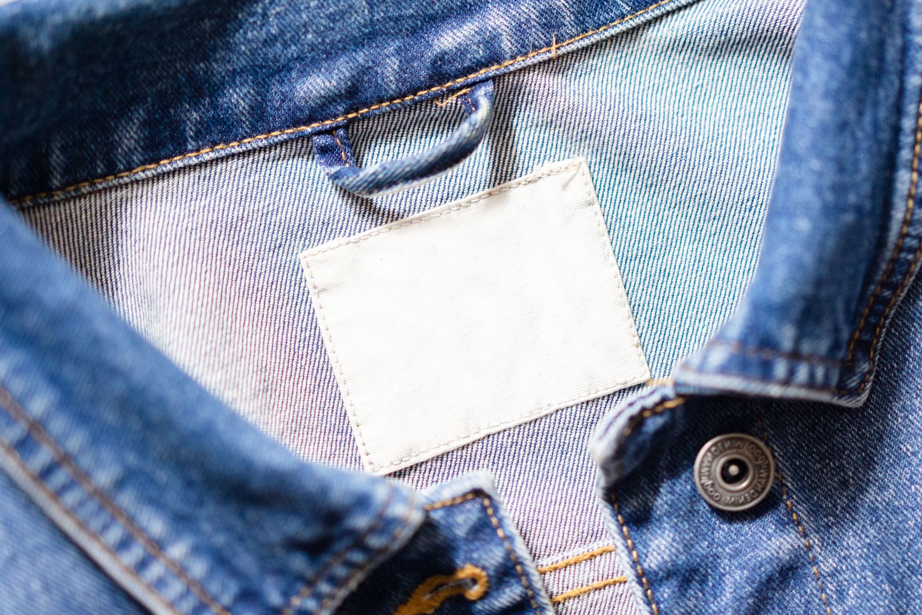 Blank white care label sewn inside a denim collar