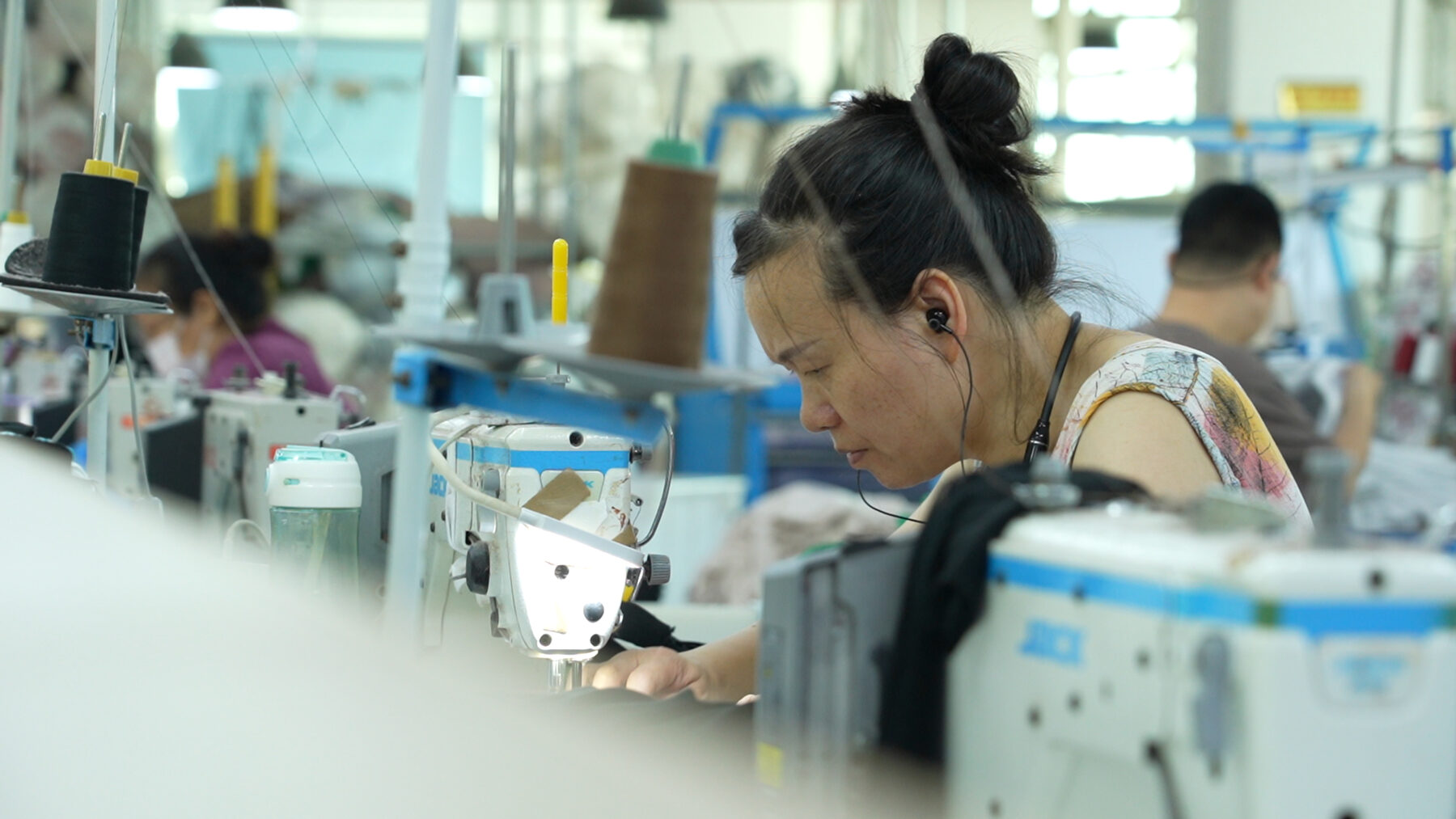 Sewing operator working at an industrial machine on our production line