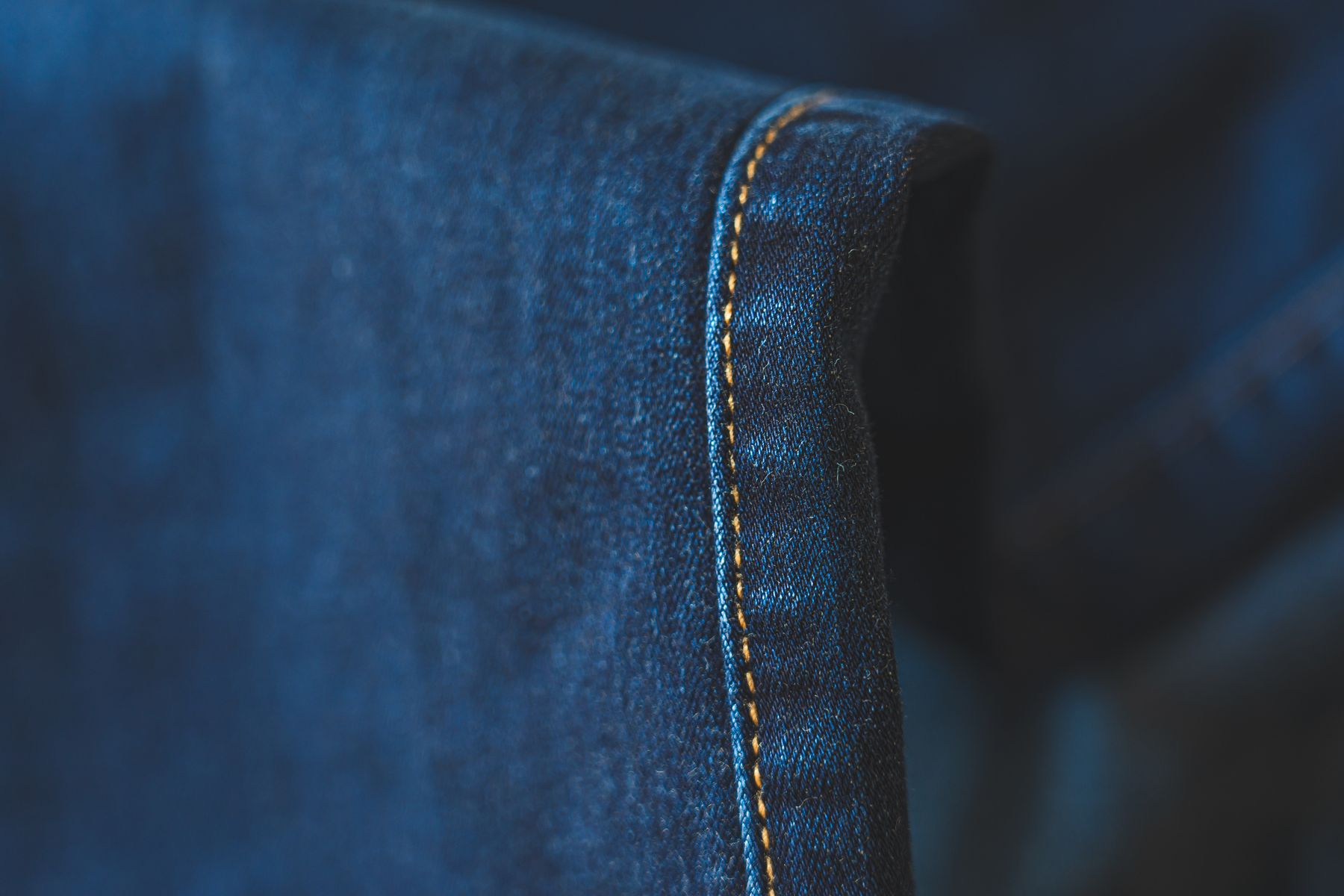 Close-up of topstitched seams running along a garment edge