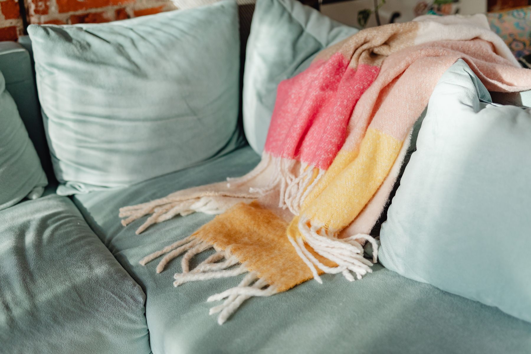Knitted throw draped across a sofa