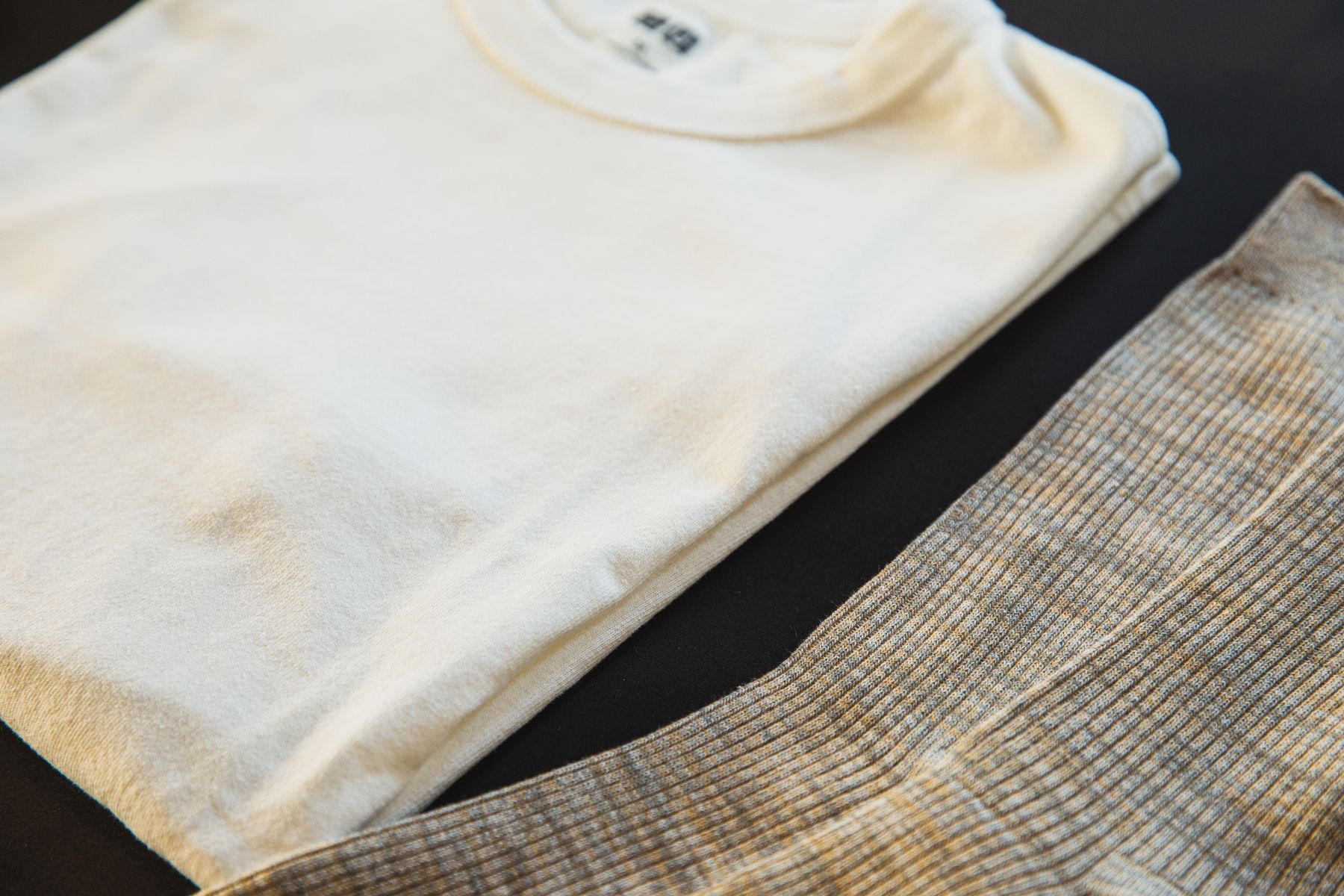 Folded top and striped trousers laid out together as a set
